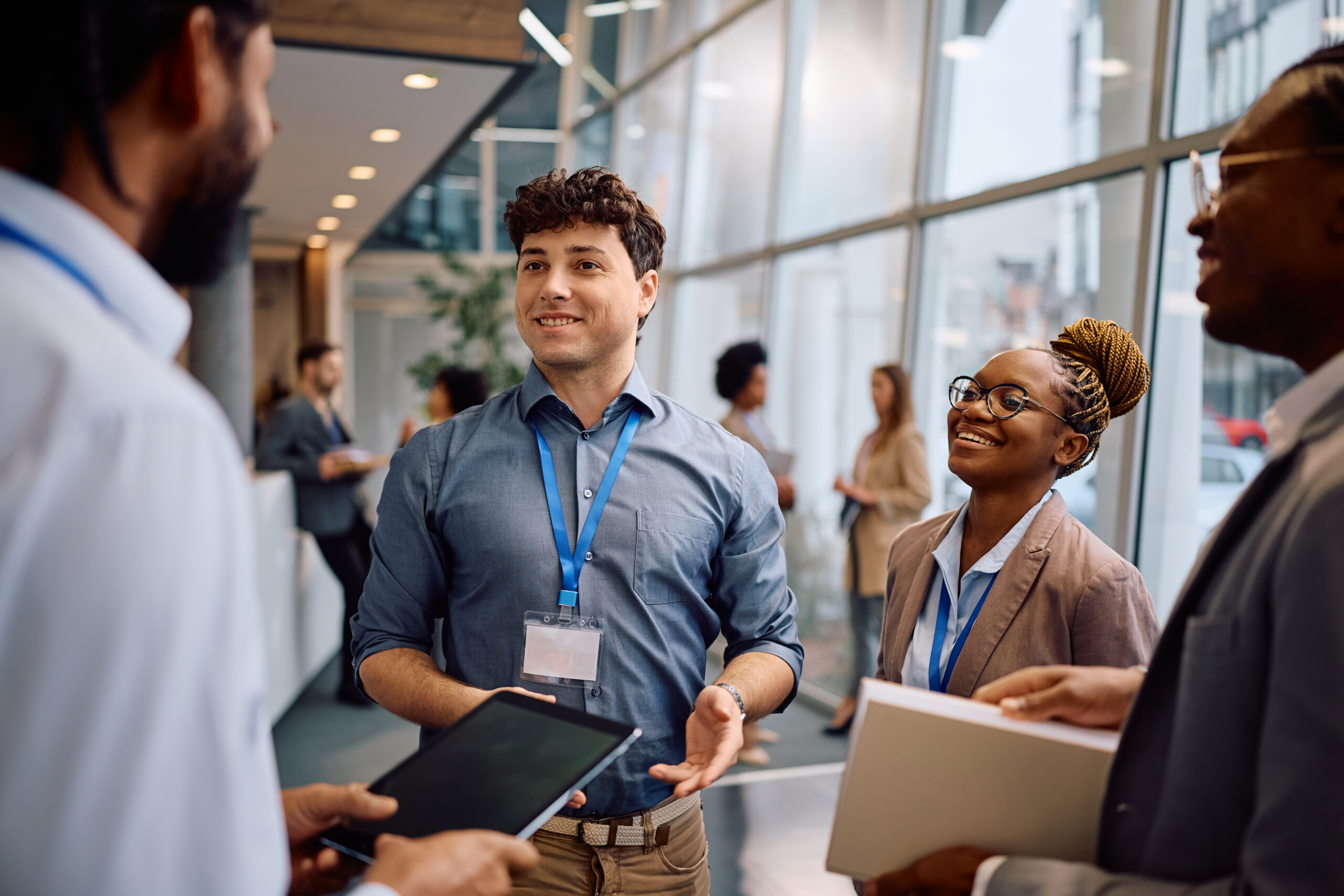 Young business professionals exchanging introductions and networking at a professional event.